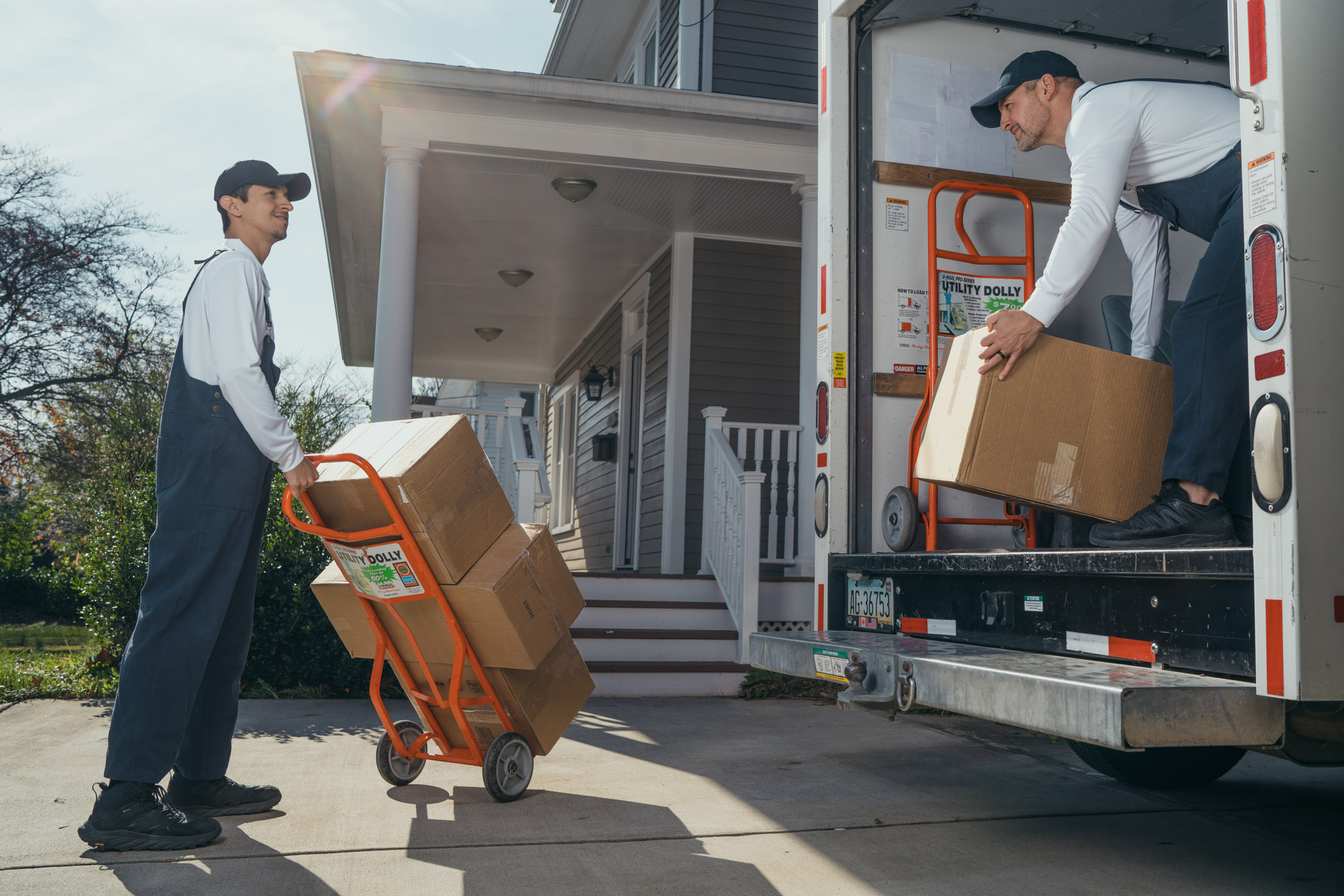 Movers moving boxes off truck