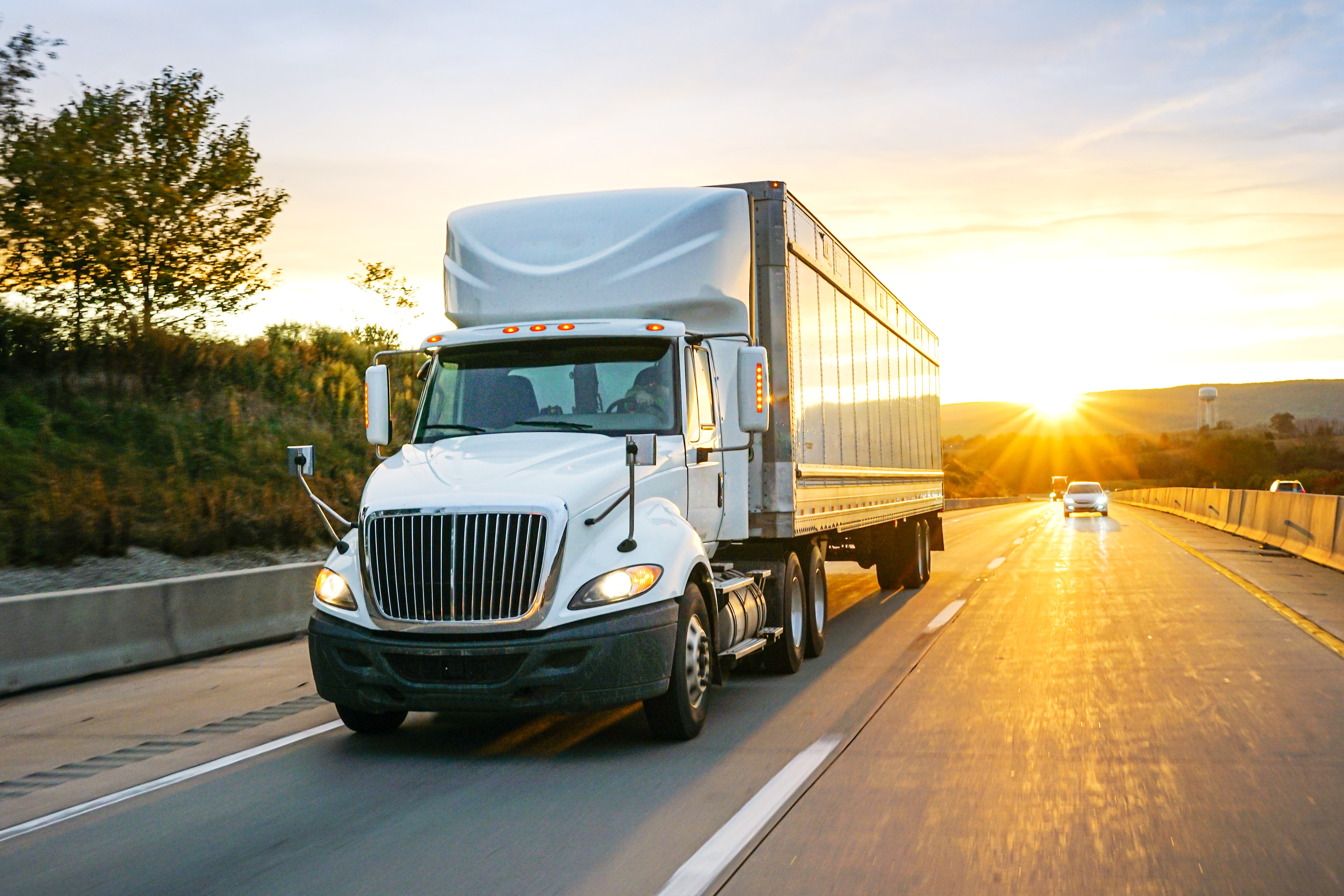 truck on road at sunset