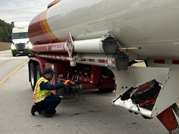 Inspector inspects a tanker truck. 