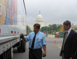 Neil Gubernat, Giant driver, shows Dr. Matthew Rizzo one of the physical tasks involved in checking his truck