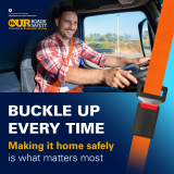 Male driver behind wheel buckled up in truck