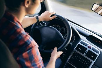 Over the shoulder view of a driver in cab