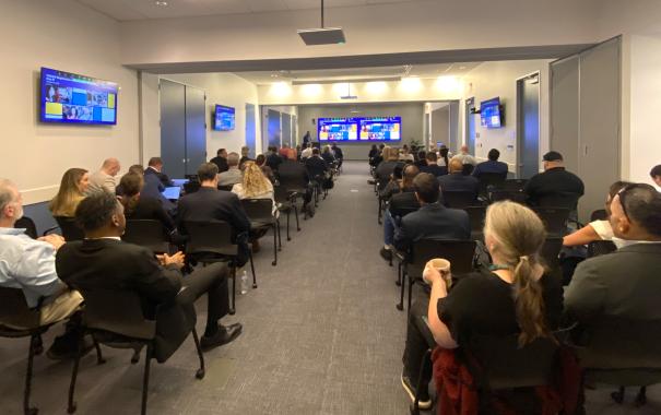 conference room with people watching presentation