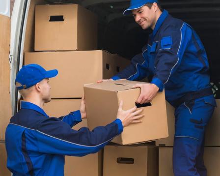 Movers loading boxes into a truck