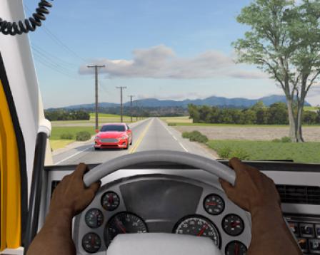 Looking out the front windshield of the truck from the point of view of the driver