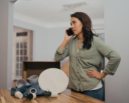 A woman on the phone with her hand on her hip