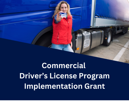 Woman hold driver's license in front of truck